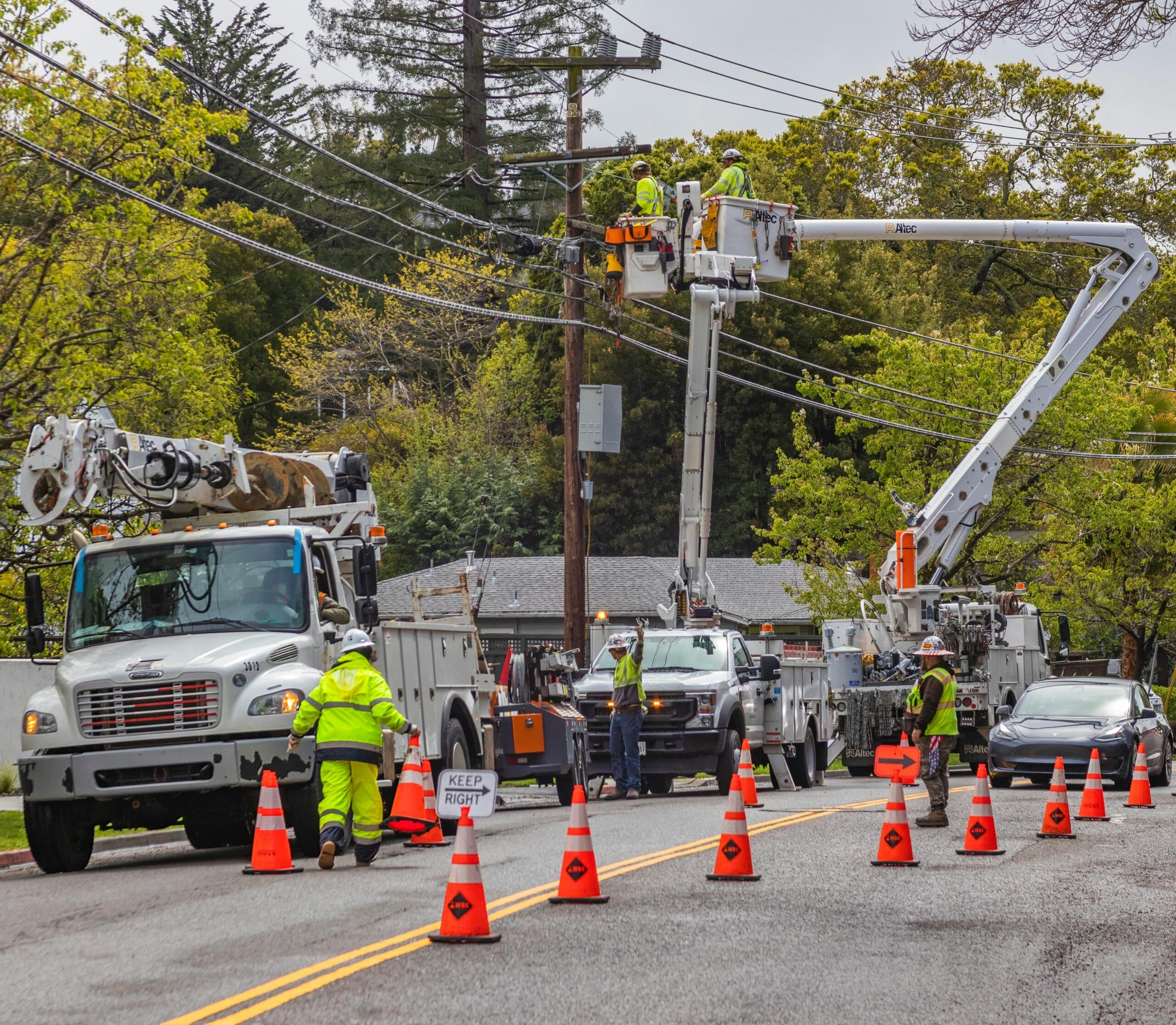 Utility truck with cherry picker working on utility lines